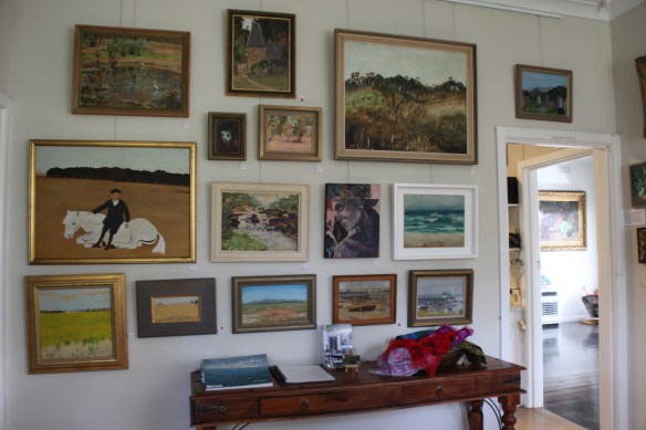 Paintings on this wall include: Sonia Skipper, Alan Martin, Margo Knox, Maurice Hurry, Clem Christesen, Tony Muratore, Joe Hannan, Jenni Mitchell, Mervyn Hannan, Lena Skipper, Leslie Sinclair
